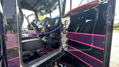 The floor is also painted black with purple and pink stripes to extend the exterior striping inside the cab.