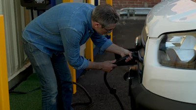 Family Laundry co-owner David Macquart-Moulin charges one of the company’s all-electric Ford E-Transit vans.