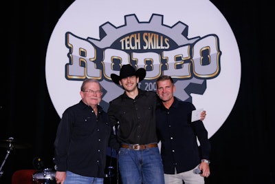 Dom McConnell (center), technician at Rush Truck Centers – Orlando South, was named the all-around Grand Champion at the 2025 Rush Enterprises’ Tech Skills Rodeo Tuesday in Nashville. He is flanked by Rush Chairman, President and CEO Rusty Rush (left) and Clint Bowyer.
