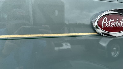 McKinney had a shine for the Evergreen Frost paint color, and he had Lady Lines Pinstriping come and hand-paint a gold leaf stripe with a green stripe underneath all the way around the truck.