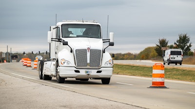 An electric heavy-duty truck provided by Cummins charges as it drives along a test segment on U.S. Highway 52/231 in West Lafayette, Indiana.