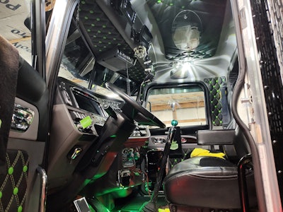 The rig's button-tuck interior matches the black and green exterior of the unit.