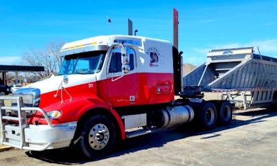Mackey's '07 Freightliner Columbia, hooked to a hopper. Note the 'square stacks' the owner-operator engineered himself after realizing how much (roughtly $3K) a shiny kit was going to cost him. More detail in this brief Youtube explanation of just what all he used for them.