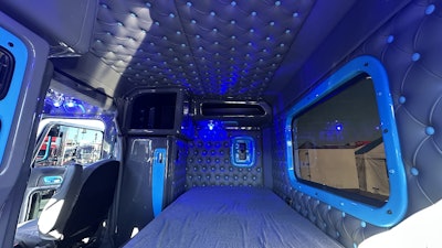 The button-tuck upholstery matches the rig’s gray and baby blue exterior.