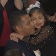 Marcus Coleman holding his daughter, Dalilah, at the 2026 State of the Union address.