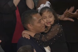 Marcus Coleman holding his daughter, Dalilah, at the 2026 State of the Union address.
