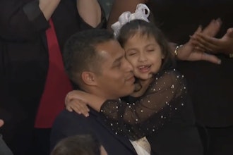 Marcus Coleman holding his daughter, Dalilah, at the 2026 State of the Union address.
