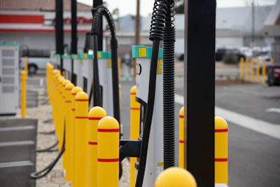 A row of battery-electric commercial vehicle charging stations at EV Realty's San Bernardino, California hub.