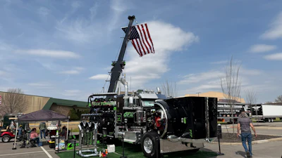 Overdrive Pride & Polish champ Clifton Parsley's 'Heavy Hook' 2024 Peterbilt 389 heavy tow truck proudly displays the American flag.