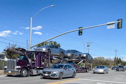 Car Haul Semi Truck Traffic Light Getty Images 2116497008
