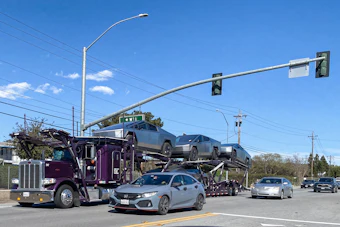 Car Haul Semi Truck Traffic Light Getty Images 2116497008