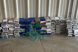 Inside the rear of the trailer, several duffle bags and cardboard boxes were found, containing approximately 392 pounds of suspected cocaine.