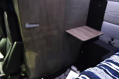 Door closed. Bed positioned along the driver's side of the sleeper in this unit.