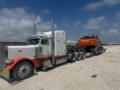 Robert 'Rocket' Miceli hauls heavy and specialized freight with this 2004 Peterbilt 379. This photo was taken when he picked up the Hitachi excavator stolen while his truck was in the shop for an engine repair.