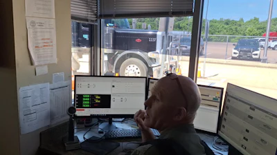 Pictured here with carrier-screening displays and a view of a rig being weighed, Trooper Johnson noted that there's no single factor that most influences any decision to pull in a unit for inspection. Given the Giles County scale's 100% pull-in rate, though, 'we see a lot of the same trucks in here every single day,' he said. Inspectors get a good feel for who's on top of their game and who's not, regardless of a company's Inspection Selection System score. (Bypass systems utilize the ISS score in their software to deliver bypass or pull-in instructions to operators.)