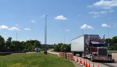Inspectors still utilize sorting capabilities of the two common weigh station bypass systems, but the bypass actually runs behind the building within the facility, as noted stretching an entire mile from initial exit until it rejoins I-65. The point of bypass is visible in the image here -- the truck in the background is taking it, while the Peterbilt in the foreground is inching up to the weight platform.