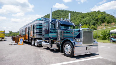 'Daddy Let Me Drive' is a 1997 Peterbilt 379 coupled with a matching custom 1996 Streamliner Deluxe 15-horse trailer, owned by John T. Barker Jr., and operated and shown by John T. Barker III.