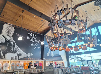Vaulted celings inside the dining hall and apparel/C-store (as shown here) give the place a wide-open, inviting feel. The store's center features the massive chandelier, festooned with guitars.