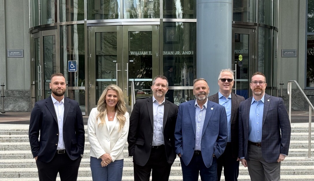 Outside DOT headquarters in Washington, D.C. Left to right: Alex Panfilov of Verified Carrier, Danielle Spinelli of GenLogs, Scott Cornell from TAPA, Dale Prax of FreightValidate, Tom Cornett with Descartes, and Shawn Rasmore from Truckstop.com. Also present were reps from Highway and The Bannon Report.