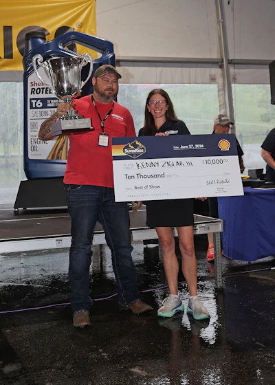 Kenny Ziglar II with the big trophy and the big check, shown here with Shell Rotella Brand Manager Julie Wright.