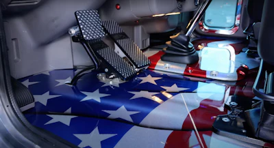 But inside, it's clear as day with the American flag painted on the floor. In the engine compartment, the fan blades are painted with stars to continue the theme.