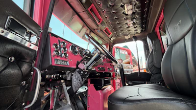The interior features a pink-painted dash to match, hardwood floors, and custom-made kick panels.