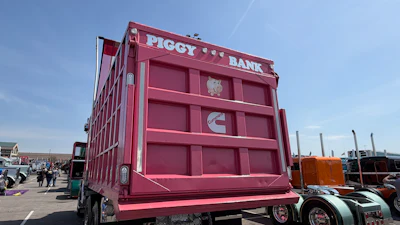 The truck's hard-working history and new color earned it the 'Piggy Bank' nickname, emblazoned across the top of the dump body.