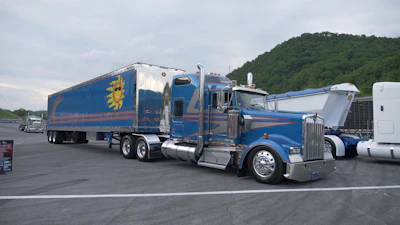 Chris McCay's 1998 Kenworth W900L: Operating out of New Jersey, Chris spends his time hauling large live trees and equipment for rock and roll bands, most recently stepping in to haul for Journey. His rig features a rare 72-inch Studio Sleeper package and custom graphic artwork inspired by a real face.