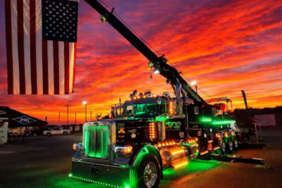 The truck itself doesn't feature patriotic graphics, but owner Clifton Parsley's 'Heavy Hook' 2024 Peterbilt 389 tow truck can be seen at various truck shows throughout the year hoisting Old Glory high above the parking lot.