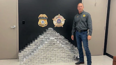 Livingston Parish Sheriff Jason Ard is shown with the methamphetamine seized at roadside from a tractor-trailer.