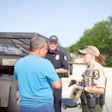 'You're picking up in Wyoming? I thought you just said South Dakota?' FMCSA Administrator Derek Barrs looks on as an inspector grills a driver during the second wave of Operation Highway Shield.