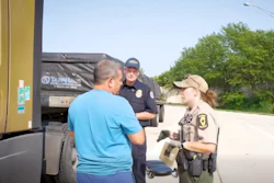 'You're picking up in Wyoming? I thought you just said South Dakota?' FMCSA Administrator Derek Barrs looks on as an inspector grills a driver during the second wave of Operation Highway Shield.