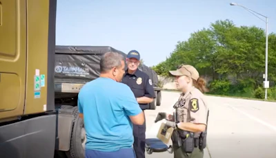 'You're picking up in Wyoming? I thought you just said South Dakota?' FMCSA Administrator Derek Barrs looks on as an inspector grills a driver during the second wave of Operation Highway Shield.
