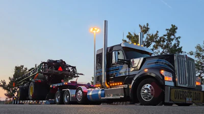 One among TruckWise's 10 units today is this W990 hooked to one among oversize loads for the agriculture and construction industries.