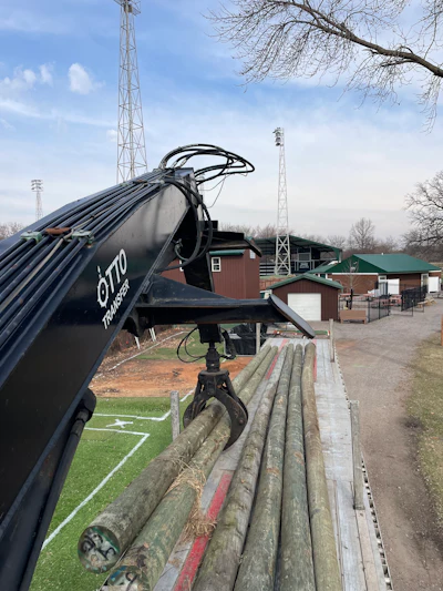 The unloader is shown in operation delivering to a baseball field.