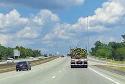 Flatbed With=poles Wood On Highway