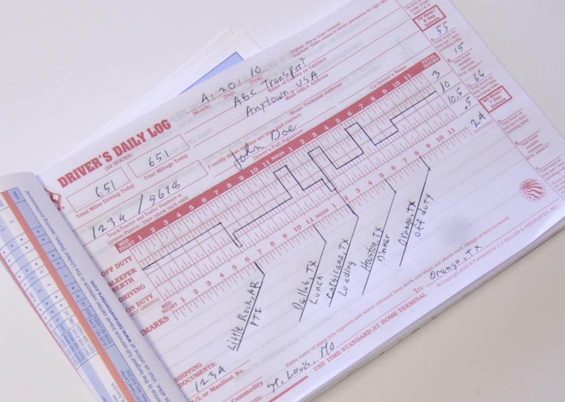 Completed driver's daily log form with handwritten entries tracking hours and vehicle information