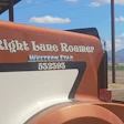 Right Lane Roamer Western Star RV trailer with rust orange and cream exterior parked in rural landscape