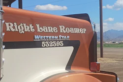Right Lane Roamer Western Star RV trailer with rust orange and cream exterior parked in rural landscape