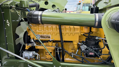Caterpillar 3116 diesel engine installed in military vehicle with yellow and green paint scheme