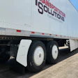 White semi-truck trailer with red and black Transportation Solutions branding and Fuel Economy Experts tagline