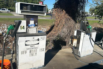 Vintage gas pumps numbered 14 with 'No Smoking' signage in outdoor setting