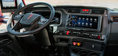 Commercial truck dashboard with steering wheel, digital display, and control panel featuring GMC badge