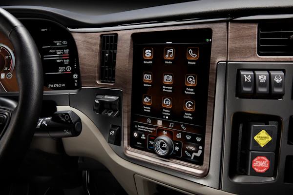 Modern vehicle dashboard with touchscreen infotainment system displaying app icons and controls