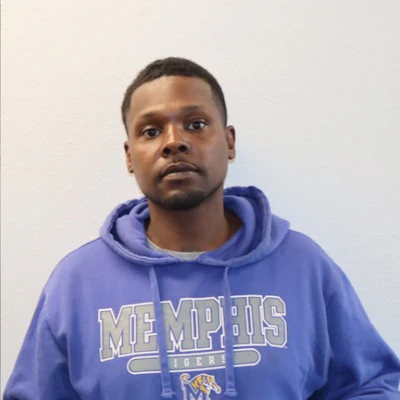Person wearing blue Memphis Tigers hoodie against neutral background