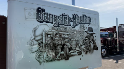 Gang Starr Fader mural artwork on white RV trailer featuring vintage car and illustrated figures in black and white