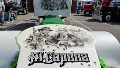 Custom vehicle hood with Alliganner branding and vintage-style portrait illustration at outdoor car show